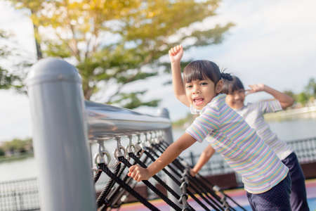 Little school kids climbing in the school playground.の写真素材