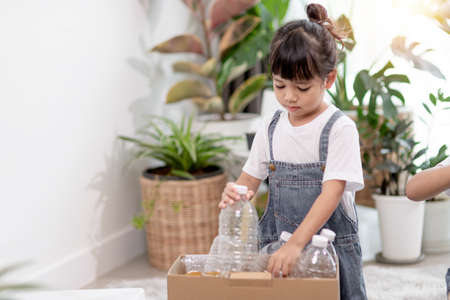 Little Girl holding plastic bottles for recyclingの写真素材