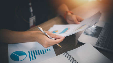 Business Woman Writing with pen in notepad
