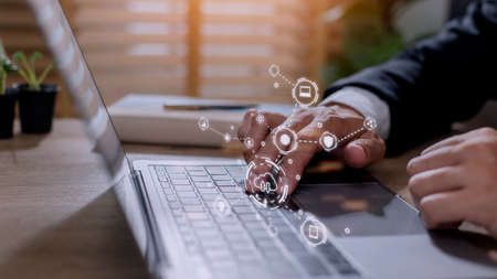 businessman working on his laptop in the office, select the icon cloud on the virtual display. Concept digital technology and cloud technologyの写真素材