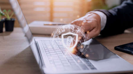 Cyber Security Internet And Networking Concept. Businessman Hand Working With laptop computer and...