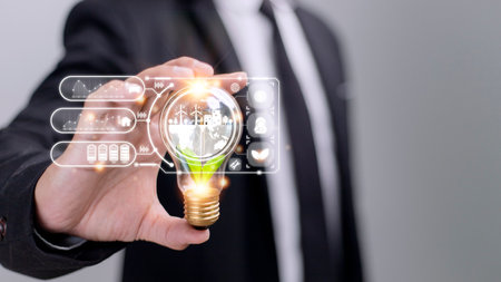 Businesswoman hand holding light bulb with esg icon on virtual screen, ESG Environmental, social and...