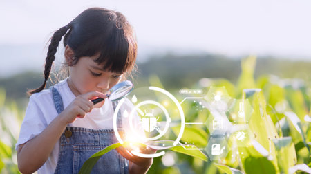 The little girl uses a tablet to analyze the growth of plants in the agricultural plot and visual...
