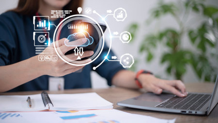 Hand holding virtual cloud computing with world and technology item such as upload download. Cloud...