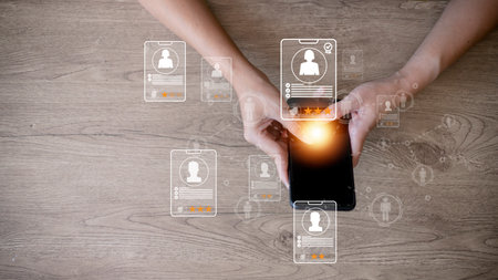 Online recruitment application specialist search service concept with virtual cards with rating and profile information on a smartphone in hand.の写真素材