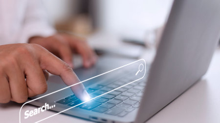 People hand using laptop or computor searching for information in internet online society web with search box icon and copyspace.の写真素材