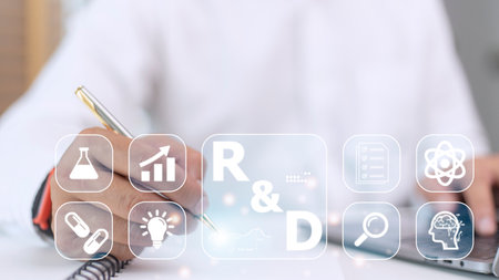 Hand of businessman holding a pen pointing to R and D icon for Research and Development on laptop screen. Manage costs more efficiently. R and D innovation concept.の写真素材