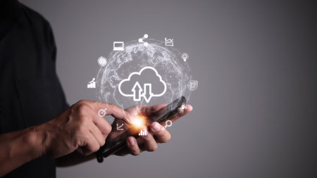 Hand holding virtual cloud computing with world and technology item such as upload download. Cloud...