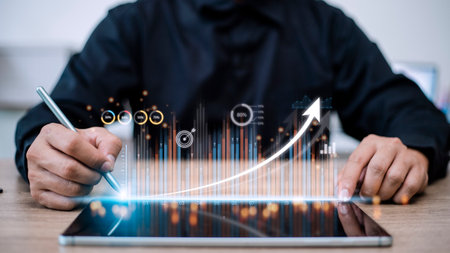 people using tablets And using his finger to touch the screen With a business graph showing up in a...