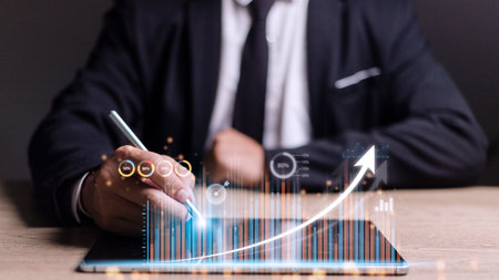 people using tablets And using his finger to touch the screen With a business graph showing up in a...