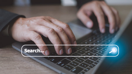 People hand using laptop or computor searching for information in internet online society web with search box icon and copyspace.の写真素材