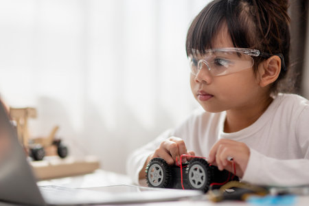Asia students learn at home in coding robot cars and electronic board cables in STEM, STEAM, mathematics engineering science technology computer code in robotics for kids concept.の写真素材