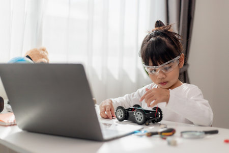 Asia students learn at home in coding robot cars and electronic board cables in STEM, STEAM, mathematics engineering science technology computer code in robotics for kids concept.の写真素材