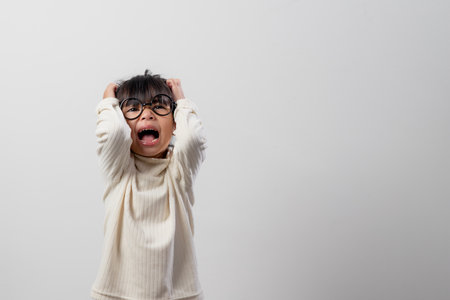 Sad little girl holds his head. little girl feeling sick, having headache.の写真素材