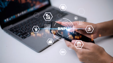 Women holding a smartphone with icons of BNPL with online shopping icons technology. BNPL Buy now pay later online shopping concept.の写真素材