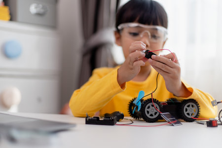 Asia students learn at home in coding robot cars and electronic board cables in STEM, STEAM, mathematics engineering science technology computer code in robotics for kids concept.の写真素材
