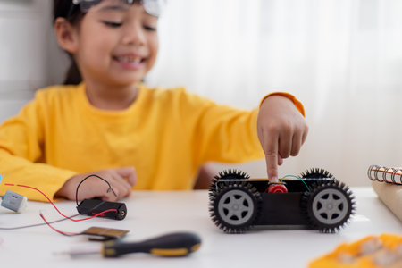 Asia students learn at home in coding robot cars and electronic board cables in STEM, STEAM, mathematics engineering science technology computer code in robotics for kids concept.の写真素材