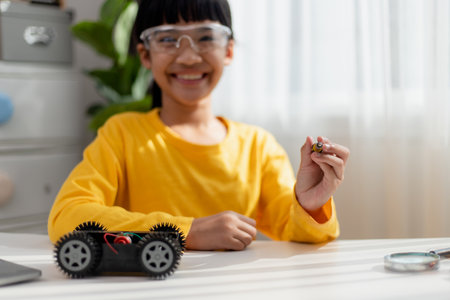 Asia students learn at home in coding robot cars and electronic board cables in STEM, STEAM, mathematics engineering science technology computer code in robotics for kids concept.の写真素材