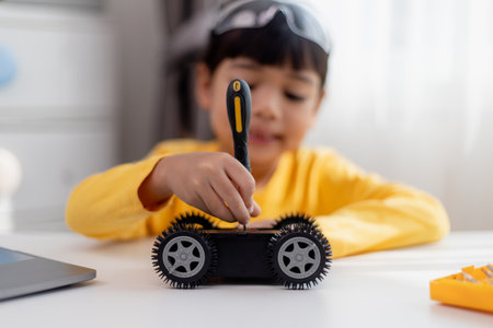Asia students learn at home in coding robot cars and electronic board cables in STEM, STEAM, mathematics engineering science technology computer code in robotics for kids concept.の写真素材