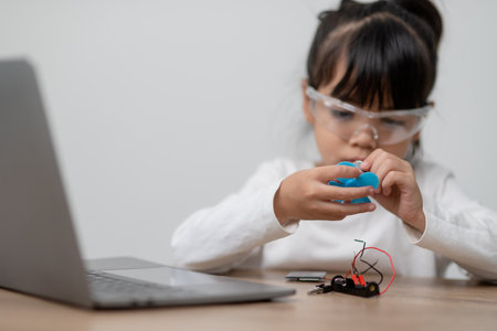Asia students learn at home in coding robot cars and electronic board cables in STEM, STEAM, mathematics engineering science technology computer code in robotics for kids concept.の写真素材