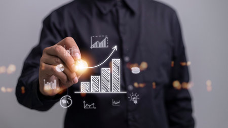 Businessman draws an increasing trend arrow and a rising chart from plan to goal. It is a representation of the idea of corporate investment development.の写真素材