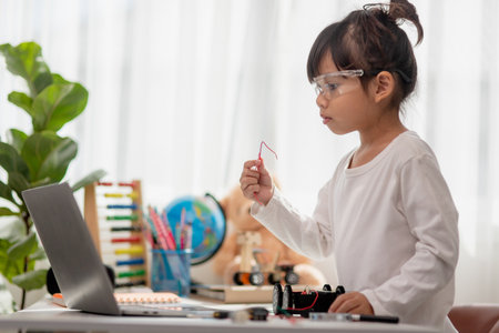 Asia students learn at home in coding robot cars and electronic board cables in STEM, STEAM, mathematics engineering science technology computer code in robotics for kids concept.の写真素材