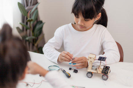 Asia students learn at home in coding robot cars and electronic board cables in STEM, STEAM, mathematics engineering science technology computer code in robotics for kids concept.の写真素材