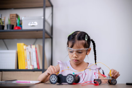 Asian students learn at home by coding robot cars and electronic board cables in STEM, STEAM,...