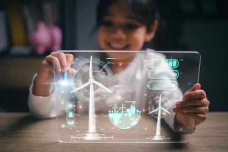 Asian little girl Works with Wind Turbine Prototype virturl, Learning about Environment and Renewable Energy. Children Working on Technology. wind energy concept. STEM Educationの写真素材