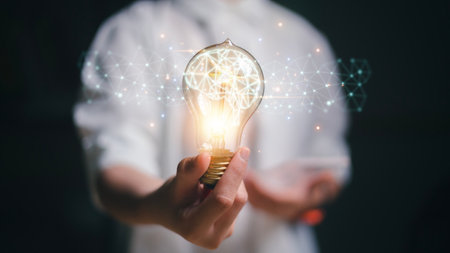 New ideas with innovative technology and creative concepts. Light bulb with a brain inside the hands...