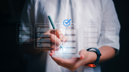 Women using smartphones with virtual screens and documents for online approval paperless quality assurance and ERP management concepts.の写真素材