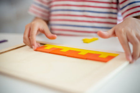 Asian girls play with puzzles, learn math, education concept