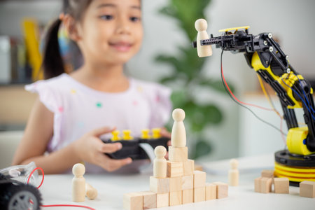 STEM education concept. Asian students learn at home by coding robot arms in STEM, mathematics engineering science technology computer code in robotics for kids' conceptsの写真素材