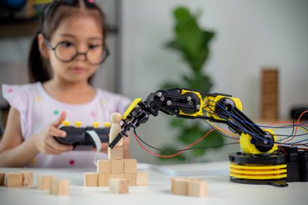 STEM education concept. Asian students learn at home by coding robot arms in STEM, mathematics engineering science technology computer code in robotics for kids' conceptsの写真素材