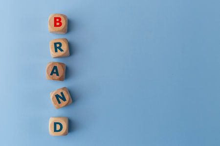 Word BAND on wooden cubes on a blue background. Business concept. Brand identity or awareness concept.の写真素材
