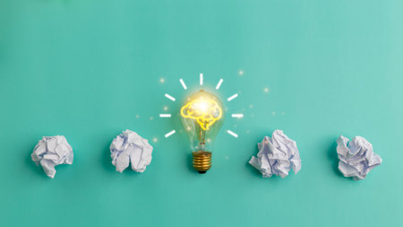 Idea concept with crumpled paper and a light bulb on a blue background. Creative thinking ideas and...