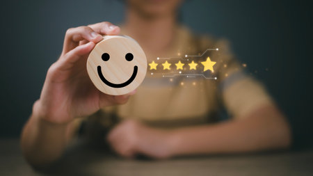 Customer review, customer service evaluation, and satisfaction concept. A businesswoman selects the smiley icon and gives five stars on a wooden block.の写真素材