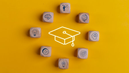 Knowledge and teaching. Wooden cubes with graduation and education symbols. Success and necessary skills in graduation or education.の写真素材