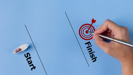 A boat floats from the start line towards the finish line drawn by a hand and target icon. Goal...