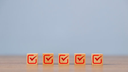 Checklist, Check mark icons for the jobs list on the wooden blocks. Task lists, Surveys, Assessments, Lists, Confirm items, Quality Control goals achievement of business success.の写真素材