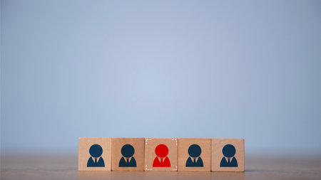 Human resource management and recruitment concept. Business hiring and recruitment selection. Career opportunity. Focus the red human icon on a wooden block choice of employee leader.の写真素材