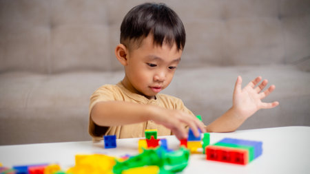The kid playing with colorful toy blocks. Little boy building the car of block toys. Educational and creative toys and games for young children.の写真素材