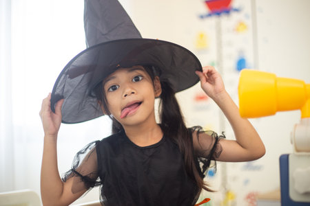 Happy Asian child girl in a witch costume to Halloween. trick or treat. Kids trick or treating.の写真素材