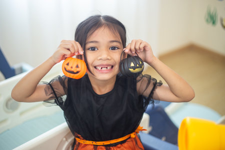 Happy Asian child girl in a witch costume to Halloween. trick or treat. Kids trick or treating.の写真素材