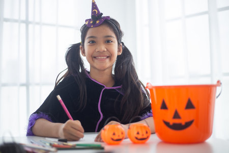 Happy Asian child girl in a witch costume to Halloween. trick or treat. Kids trick or treating.の写真素材