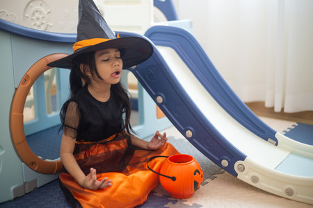 Happy Asian child girl in a witch costume to Halloween. trick or treat. Kids trick or treating.の写真素材