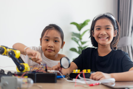 nventive kids learn at home by coding robot cars and electronic board cables in STEM. constructing robot cars at homeの写真素材