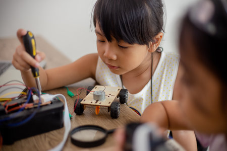 nventive kids learn at home by coding robot cars and electronic board cables in STEM. constructing robot cars at homeの写真素材