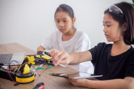 nventive kids learn at home by coding robot cars and electronic board cables in STEM. constructing robot cars at homeの写真素材