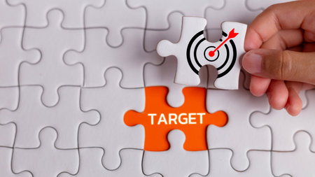 Target goal objectives in business. Initiation and synergy to reach the target. Objective, goal, or target icon on connected jigsaw puzzle pieces.の写真素材